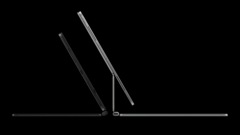 Side view of two dark-colored laptops and an iPad Pro at different angles against a black background, highlighting their thin profiles and keyboard bases.