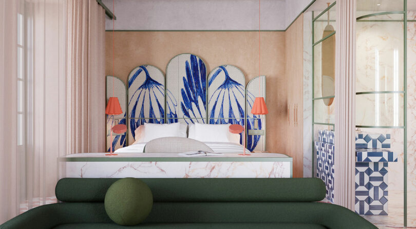 A modern bedroom with a double bed, bold blue and white mosaic headboard, green sofa, glass partitions, and pink accent lamps.