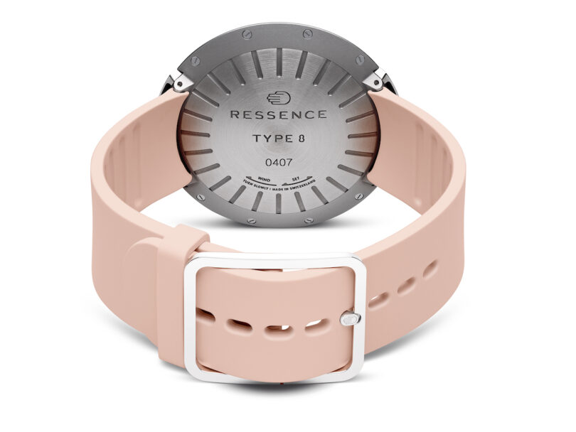 close up of the backside of A modern wristwatch with a pink band