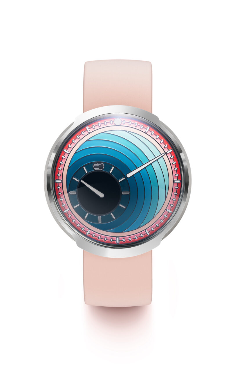 A modern wristwatch with a pink band and a circular, blue gradient face featuring concentric arcs and bold, minimalist hands