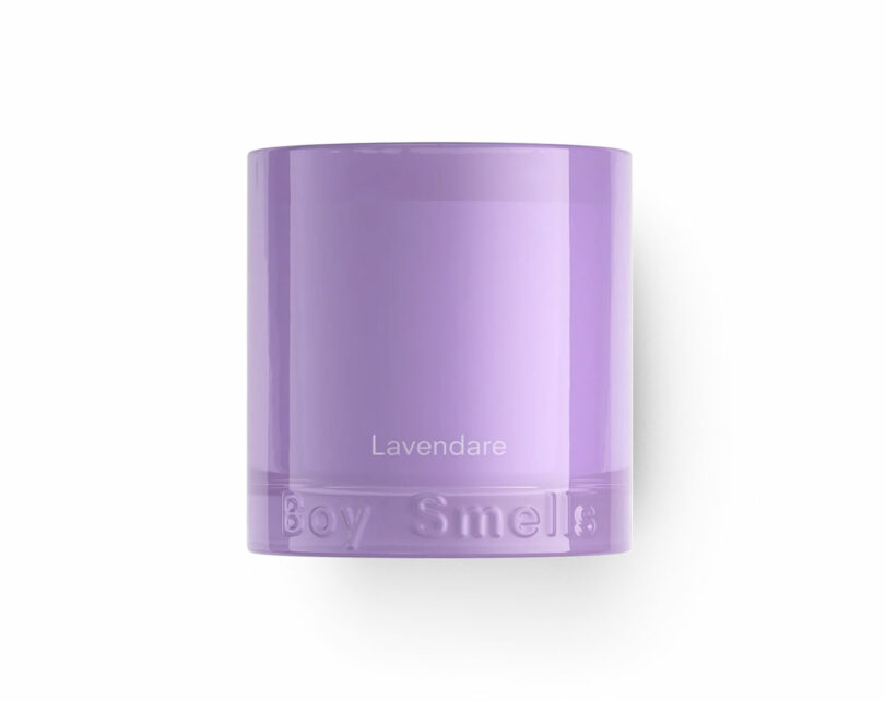 A purple candle in a glass container labeled "Lavendare" with "Boy Smells" embossed at the base.