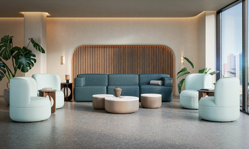 Modern lounge area with light blue chairs, a blue sofa, round coffee tables, potted plants, and large windows with a city view. Neutral colors and minimalist decor.