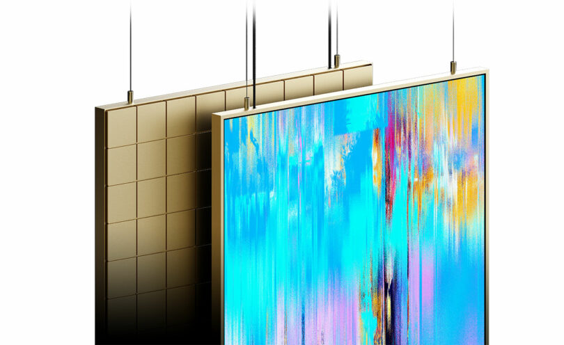 Two flat panels are suspended with cables; one panel has a metallic, grid-like surface, and the other displays a colorful, abstract digital pattern.