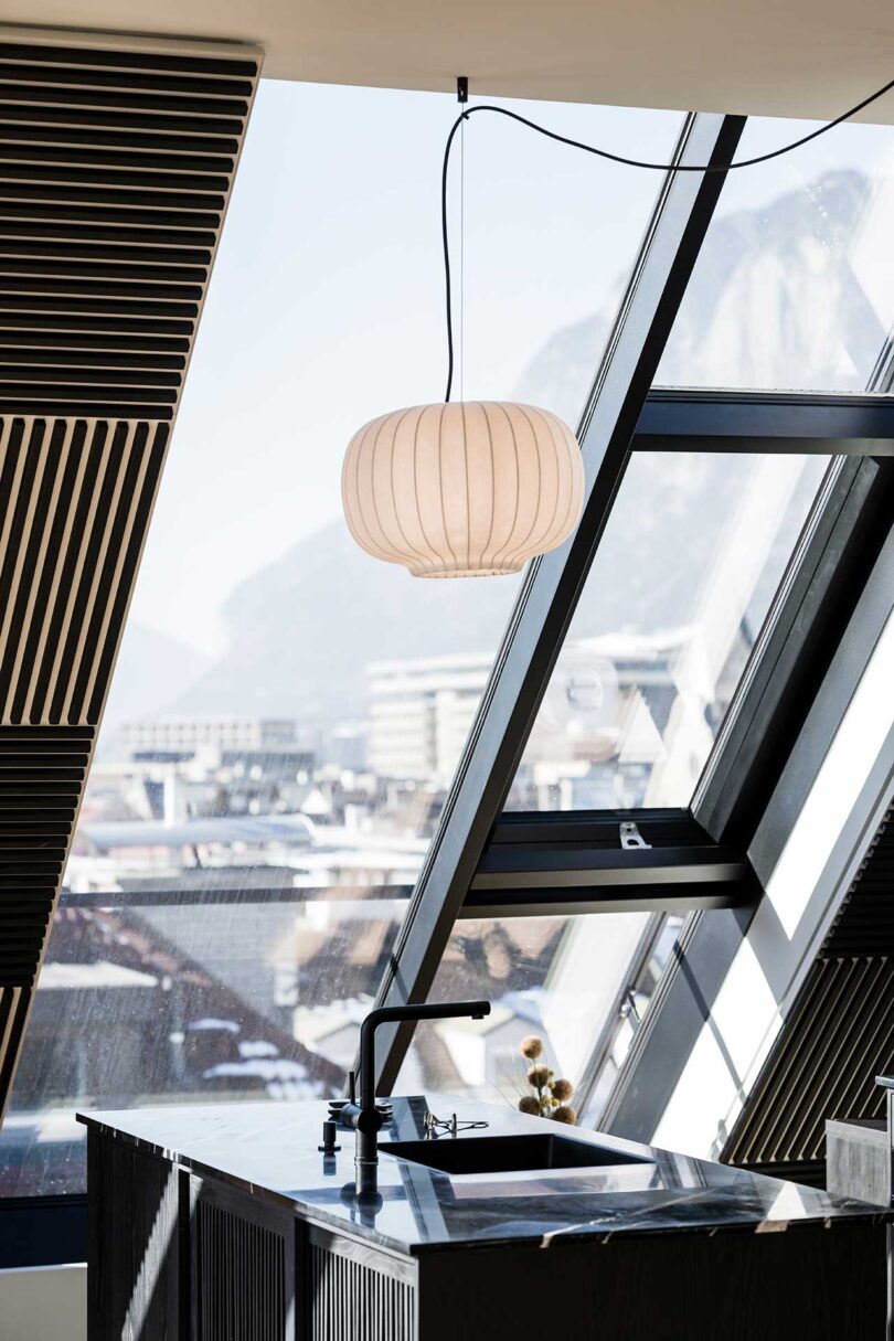 view out slanted glass walls from modern apartment